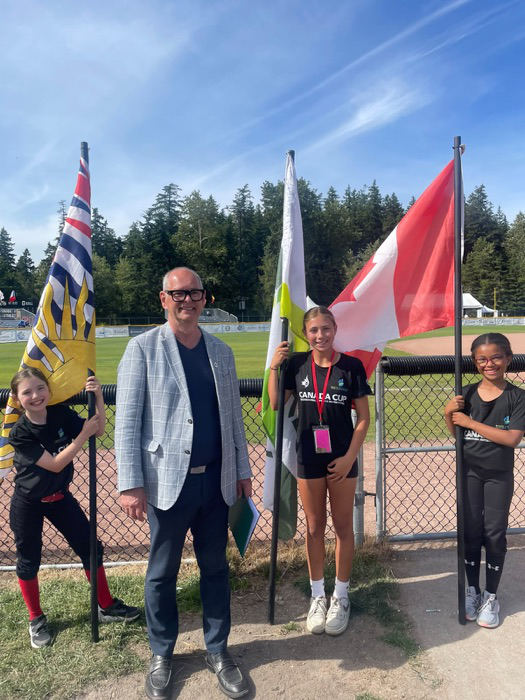 Ernie with young athletes at a community sports event
